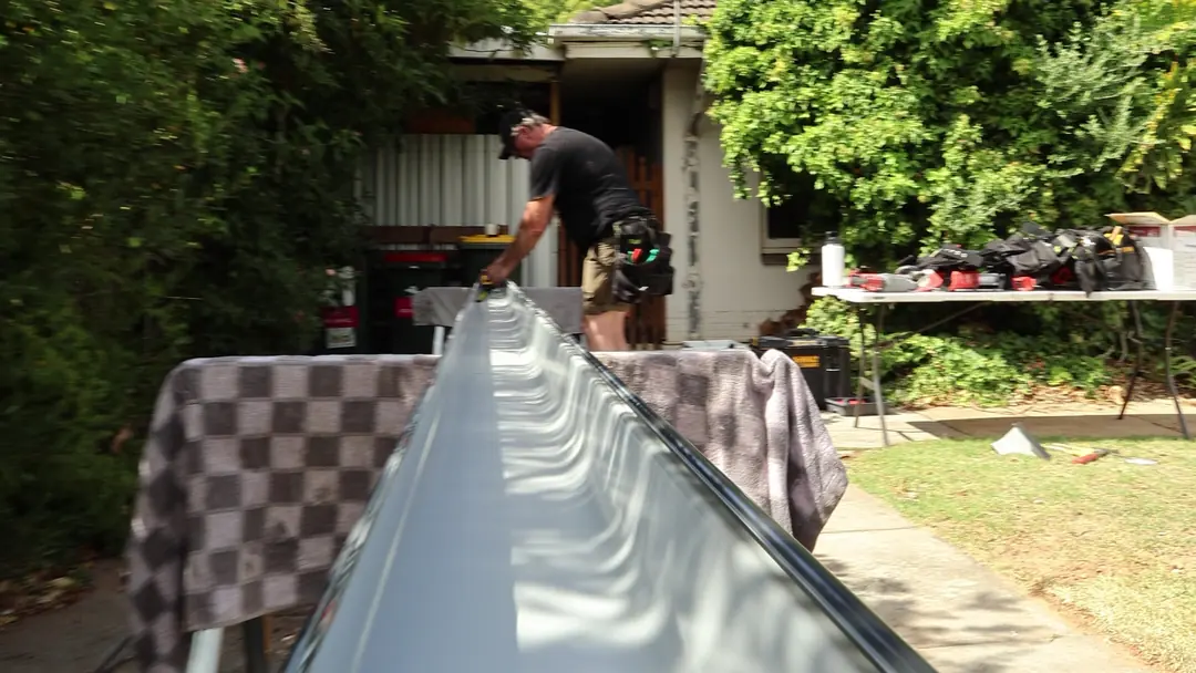 A new length of Colorbond gutter laid out on site before it goes up