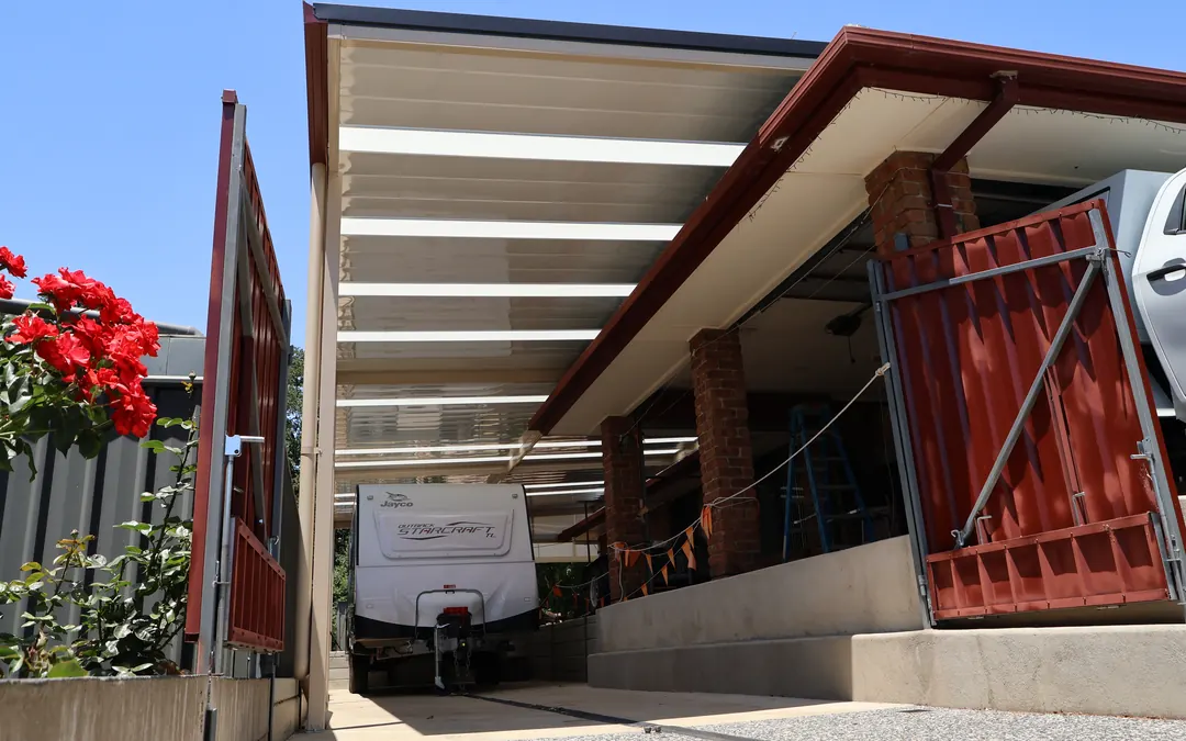 A gable verandah with clear roof panels over the driveway of a Gumeracha home