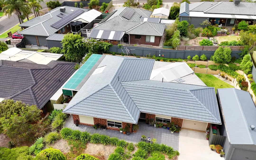 Drone view of a single-storey home with its tile roof freshly restored in grey