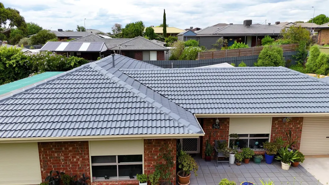 A restored concrete tile roof, recoated in grey, from the air