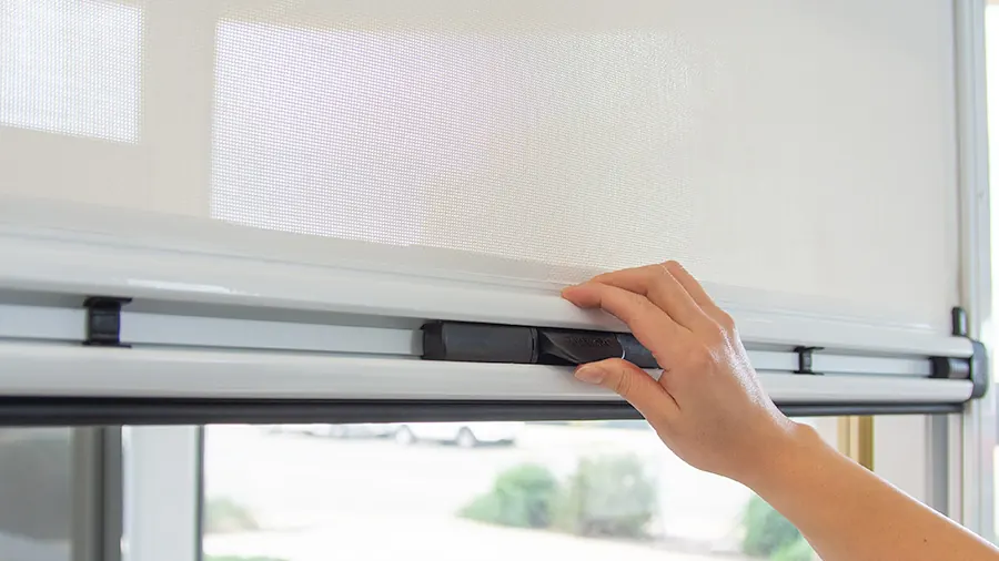 Pulling down a Ziptrak® interior blind by its handle (product photo: Ziptrak)
