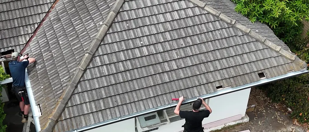 From above: the crew replacing gutters and fascia along a tiled hip roof in Somerton Park