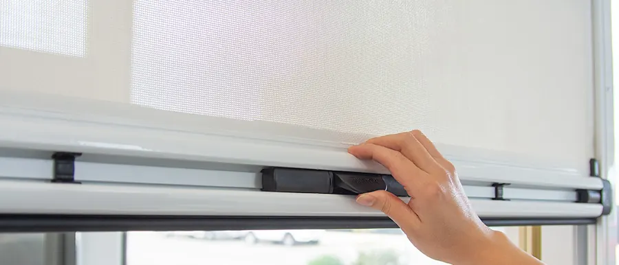 Pulling down a Ziptrak® interior blind by its handle (product photo: Ziptrak)